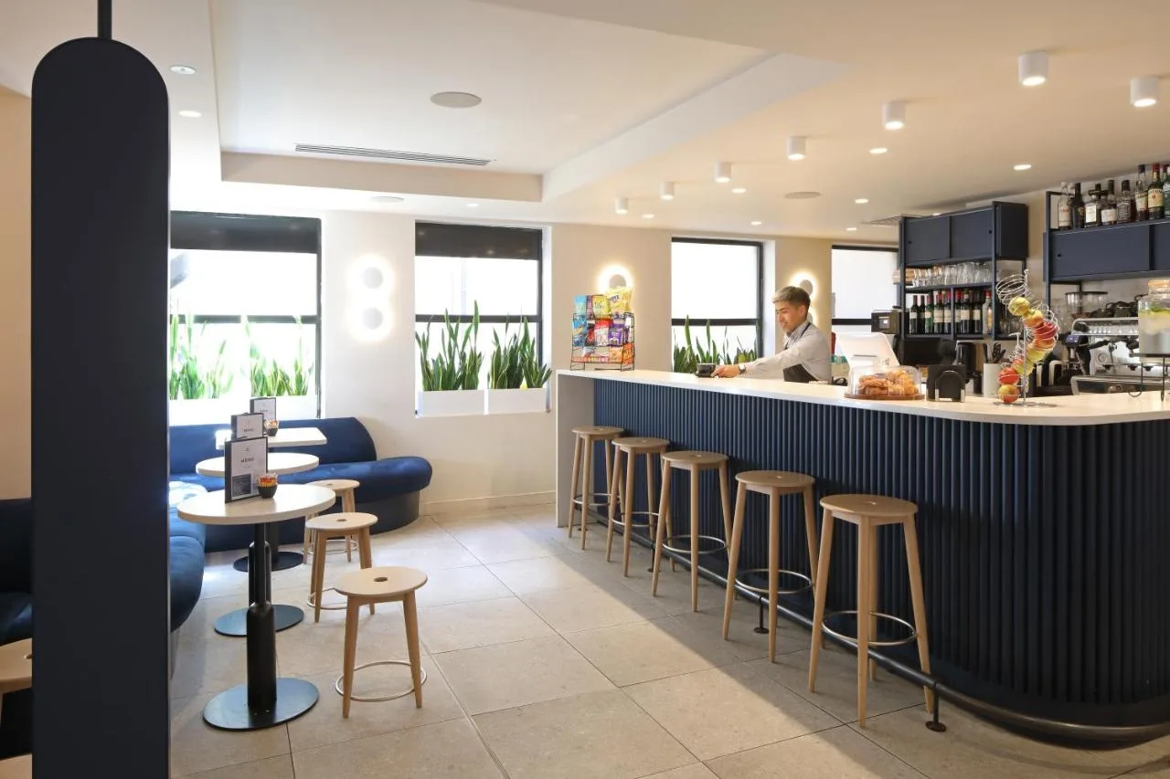 a restaurant with a bar with stools at The Z Hotel Piccadilly in London