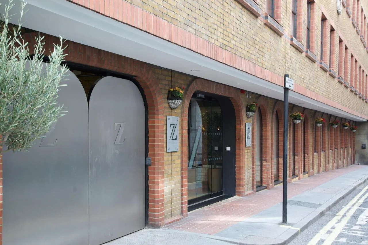 a brick building with two doors on a street at The Z Hotel Piccadilly in London